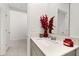 Bright bathroom featuring a single sink vanity, modern fixtures, and decorative red accents at 350 Rustic Rail Dr, Lake Wales, FL 33859