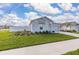 Attractive single-Gathering home with a two-car garage, green lawn, and landscaped garden beds at 350 Rustic Rail Dr, Lake Wales, FL 33859