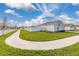 Single-Gathering home showing green lawns, fenced yard, long drive, and 2 car garage at 350 Rustic Rail Dr, Lake Wales, FL 33859