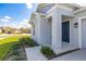 Charming home's front door entrance with well-maintained landscaping and a covered porch at 350 Rustic Rail Dr, Lake Wales, FL 33859