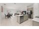Open-concept kitchen with stainless appliances, large island, and adjacent dining area at 350 Rustic Rail Dr, Lake Wales, FL 33859