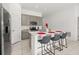 Bright kitchen features an island with seating, stainless steel appliances, and modern cabinets at 350 Rustic Rail Dr, Lake Wales, FL 33859