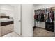 Organized walk-in closet featuring shelves, hanging racks, and ample storage space adjoining main bedroom at 350 Rustic Rail Dr, Lake Wales, FL 33859