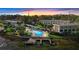 Scenic aerial view of the property with a pool, dock, and waterfront access at sunset at 402 E Orlando Ave # 18C, Ocoee, FL 34761
