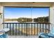Balcony overlooking a beautiful lake view, with a table and two chairs at 402 E Orlando Ave # 18C, Ocoee, FL 34761