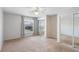 Bright bedroom with neutral carpet and a large window providing views and natural light at 402 E Orlando Ave # 18C, Ocoee, FL 34761
