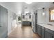Well-lit kitchen featuring gray cabinetry, stainless steel appliances, and wood-look flooring at 402 E Orlando Ave # 18C, Ocoee, FL 34761