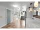 Bright kitchen with wood floors, stainless steel refrigerator, marbled countertop, and modern pendant lights at 402 E Orlando Ave # 18C, Ocoee, FL 34761