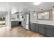 Updated kitchen with grey cabinets, stainless steel appliances, and wood-look flooring at 402 E Orlando Ave # 18C, Ocoee, FL 34761