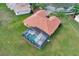 Drone view of a single-Gathering home featuring a screened-in pool and a terracotta tile roof at 4036 Bougainvillea Pl, Kissimmee, FL 34746