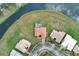 Overhead view of a tile roof house highlighting its screened-in pool and manicured lawn near a quiet cul-de-sac at 4036 Bougainvillea Pl, Kissimmee, FL 34746