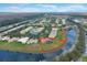 Picturesque aerial shot of a well-maintained neighborhood with a serene lake view, highlighting its peaceful setting at 4036 Bougainvillea Pl, Kissimmee, FL 34746