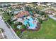 Aerial view of a community clubhouse with a large pool, playground, and ample parking in a well-maintained neighborhood at 4036 Bougainvillea Pl, Kissimmee, FL 34746