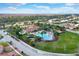 A beautiful community pool and clubhouse surrounded by lush landscaping and well-maintained homes in an aerial view at 4036 Bougainvillea Pl, Kissimmee, FL 34746