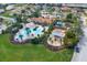 An aerial view showcases a community pool, clubhouse, and playground, surrounded by green spaces and residential homes at 4036 Bougainvillea Pl, Kissimmee, FL 34746