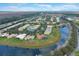 Expansive aerial view of a residential community, featuring homes with lush lawns and scenic waterways at 4036 Bougainvillea Pl, Kissimmee, FL 34746