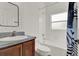 Bathroom with a white shower, a wood vanity and a modern mirror at 4036 Bougainvillea Pl, Kissimmee, FL 34746