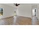 Minimalist bedroom with wood floors, a ceiling fan, and a bright window at 4036 Bougainvillea Pl, Kissimmee, FL 34746