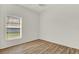 Clean, light-filled bedroom with a window and wood-look flooring at 4036 Bougainvillea Pl, Kissimmee, FL 34746