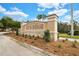 Entrance to Isles of Bellalago community with manicured landscaping and an elegant sign that reads, 