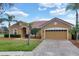Attractive single-story home features a red tile roof, two-car garage, and well-maintained landscaping at 4036 Bougainvillea Pl, Kissimmee, FL 34746