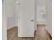 Hallway featuring hardwood floors and white doors at 4036 Bougainvillea Pl, Kissimmee, FL 34746