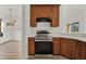 A kitchen boasts stainless steel appliances, wood cabinets, and white countertops, exuding a modern and clean aesthetic at 4036 Bougainvillea Pl, Kissimmee, FL 34746