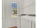Bright laundry room with modern appliances and a window for natural light at 4036 Bougainvillea Pl, Kissimmee, FL 34746
