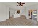 Bright living room with hardwood floors flowing into the kitchen and a sliding glass door at 4036 Bougainvillea Pl, Kissimmee, FL 34746