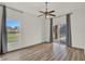 Bright bedroom featuring wood floors and a sliding door to the screened-in porch at 4036 Bougainvillea Pl, Kissimmee, FL 34746