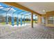 Outdoor patio showcasing a screened-in pool with brick pavers for luxurious relaxation at 4036 Bougainvillea Pl, Kissimmee, FL 34746