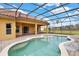 A kidney-shaped screened-in pool boasts brick pavers and offers a relaxing outdoor space at 4036 Bougainvillea Pl, Kissimmee, FL 34746