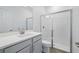 Modern bathroom featuring a glass-enclosed shower and a gray vanity with a sink at 4110 Gooseberry Trl, Kissimmee, FL 34746