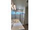 Bright bathroom featuring a glass shower, modern vanity, and stylish lighting fixture at 4110 Gooseberry Trl, Kissimmee, FL 34746