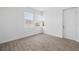 Bright bedroom with light tile flooring, three windows, and a white door at 4110 Gooseberry Trl, Kissimmee, FL 34746