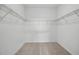 Walk-in closet with ample shelving and neutral carpeting at 4110 Gooseberry Trl, Kissimmee, FL 34746