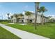 Charming clubhouse exterior featuring stone accents, lush green landscaping, and sidewalk access at 4110 Gooseberry Trl, Kissimmee, FL 34746