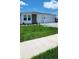 Beautiful single-story home featuring well-manicured lawn and a stone accent wall at 4110 Gooseberry Trl, Kissimmee, FL 34746