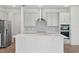 Well-lit kitchen with stainless steel appliances, a large island, and plenty of cabinet space at 4110 Gooseberry Trl, Kissimmee, FL 34746