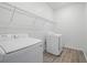 Functional laundry room featuring a modern washer and dryer, plus convenient overhead shelving at 4110 Gooseberry Trl, Kissimmee, FL 34746