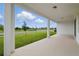 Covered patio overlooking a well-maintained lawn and a scenic community at 4110 Gooseberry Trl, Kissimmee, FL 34746