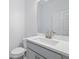 Well-appointed powder room with modern fixtures, a vanity with storage, and a pristine white finish at 4110 Gooseberry Trl, Kissimmee, FL 34746