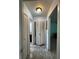 Hallway with tiled floor leading to bathroom and additional room at 4207 Continental Blvd, Orlando, FL 32808