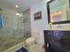 Well-lit bathroom featuring a glass enclosed shower, vanity, and commode for comfort and convenience at 4304 Clubside Dr # 4304, Longwood, FL 32779