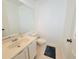 Half bathroom with white fixtures, tile flooring, a large mirror and neutral paint at 4304 Clubside Dr # 4304, Longwood, FL 32779