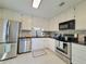 Updated kitchen with stainless steel appliances, granite countertops, and white cabinets at 4304 Clubside Dr # 4304, Longwood, FL 32779