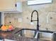 The kitchen sink features a modern faucet and beautiful tile backsplash at 4304 Clubside Dr # 4304, Longwood, FL 32779