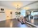 Spacious living room with hardwood floors, chandelier, and large mirror wall at 4304 Clubside Dr # 4304, Longwood, FL 32779