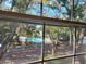 View of community pool from window featuring mature trees and ample parking at 4304 Clubside Dr # 4304, Longwood, FL 32779