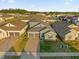 Stunning aerial view of a modern home with a manicured lawn and three-car garage at 4472 Lions Gate Ave, Clermont, FL 34711